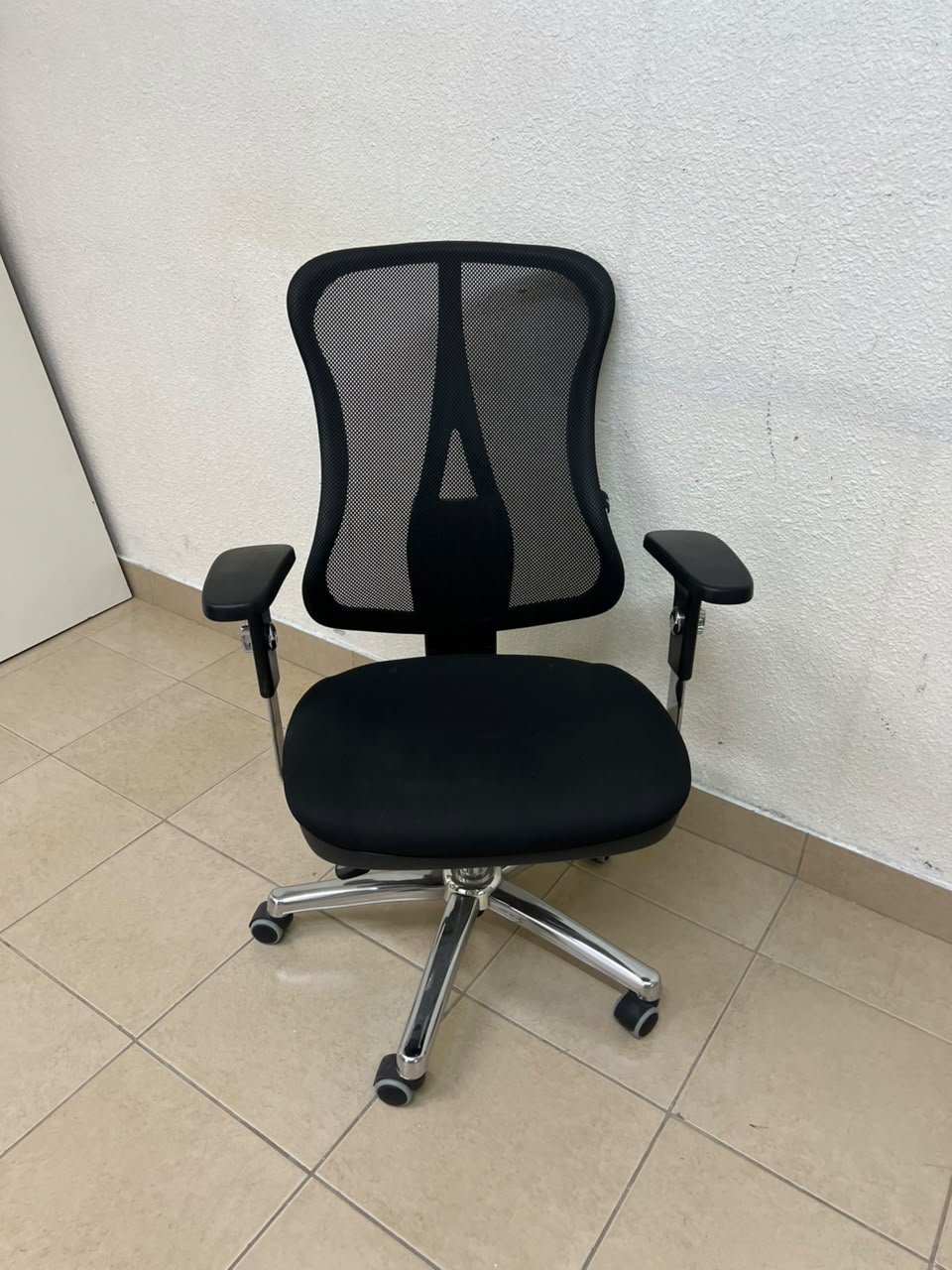 The Topstar Head Point is a comfortable office chair featuring a breathable black mesh back with built-in lumbar support and a shiny silver metal base. - Image 2