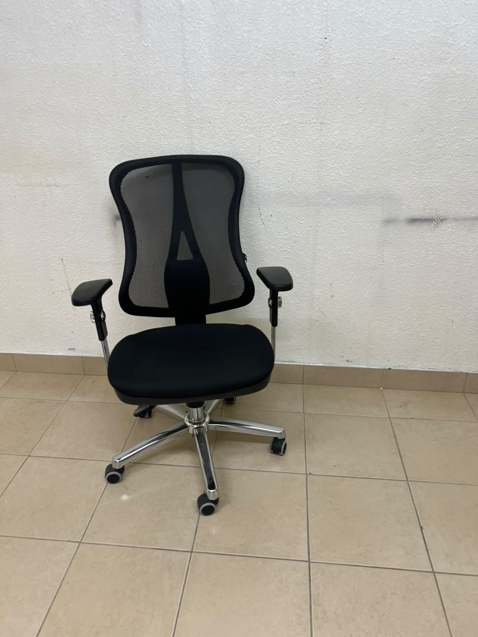 The Topstar Head Point is a comfortable office chair featuring a breathable black mesh back with built-in lumbar support and a shiny silver metal base. - Image 4