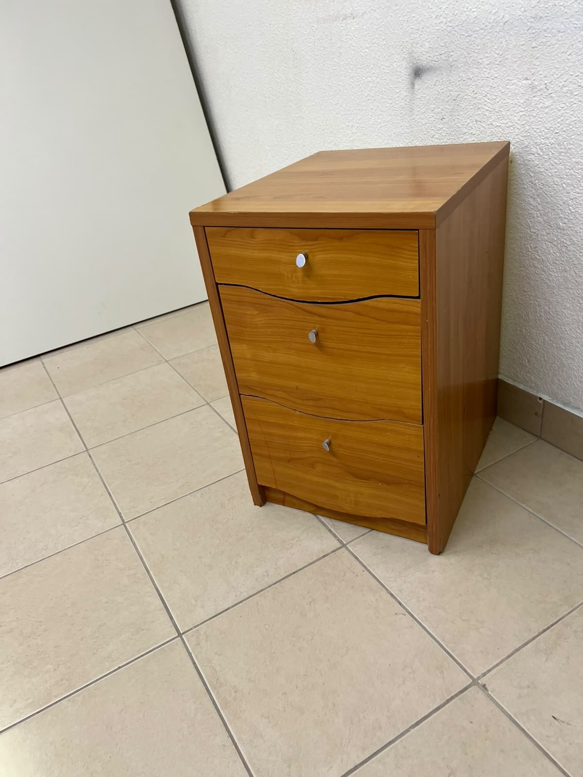 A wooden side table (nightstand) featuring three drawers with slightly curved fronts and small, round handles. - Image 7