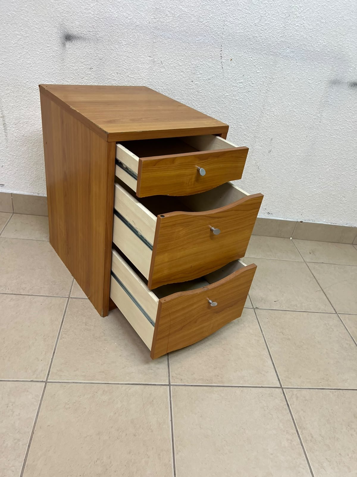 A wooden side table (nightstand) featuring three drawers with slightly curved fronts and small, round handles. - Image 8