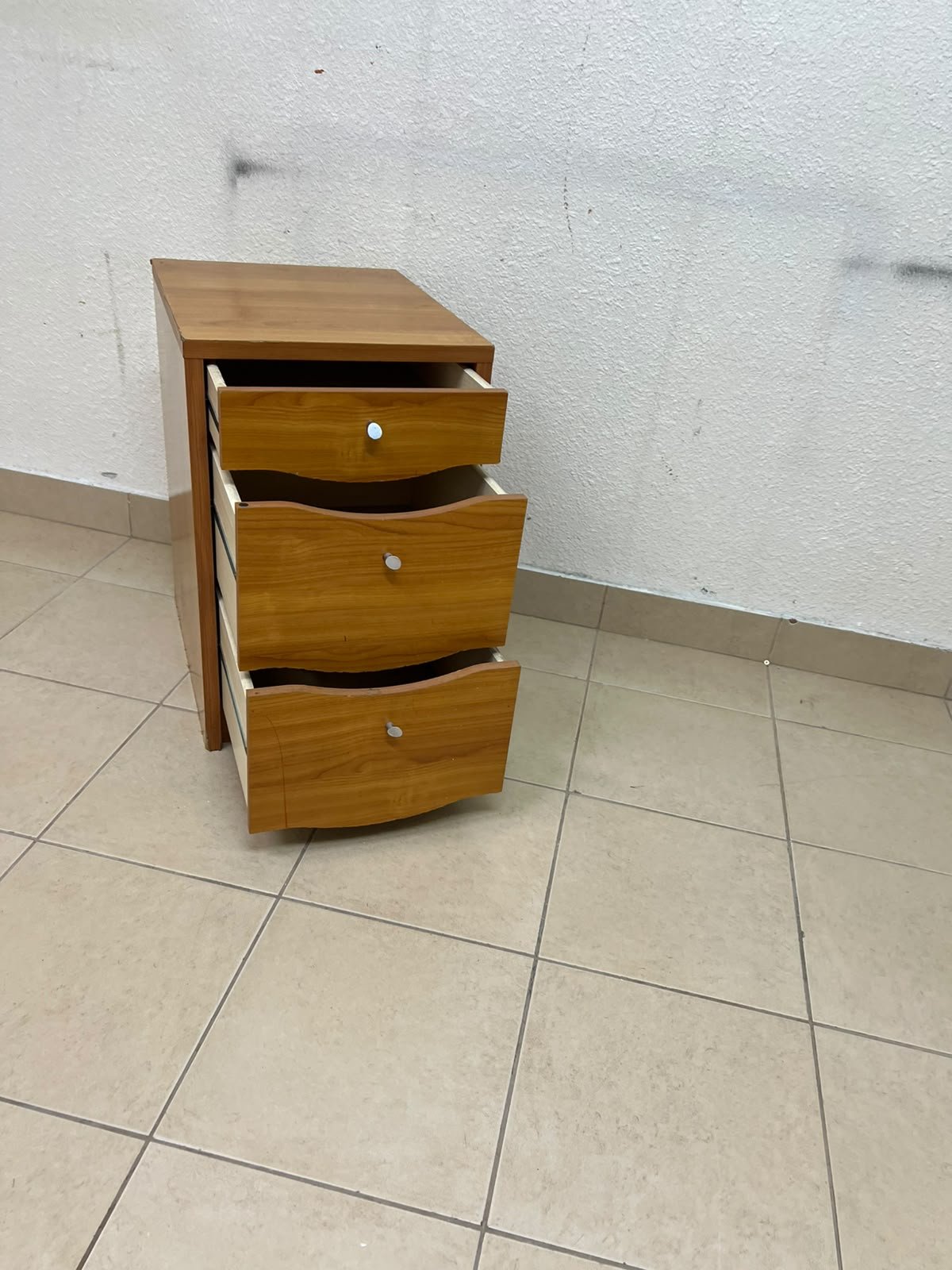 A wooden side table (nightstand) featuring three drawers with slightly curved fronts and small, round handles. - Image 3