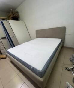 An IKEA bed with a foam and spring mattress—resembling the VALEVÅG or VESTERÖY models—featuring an upholstered bed frame in light gray or beige. - Image 4