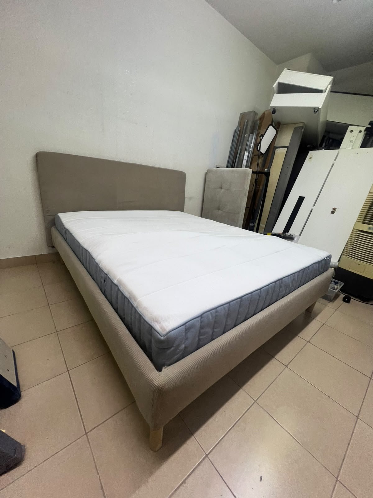 An IKEA bed with a foam and spring mattress—resembling the VALEVÅG or VESTERÖY models—featuring an upholstered bed frame in light gray or beige. - Image 5