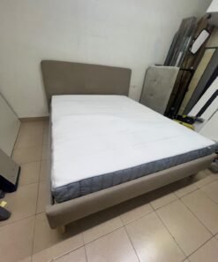 An IKEA bed with a foam and spring mattress—resembling the VALEVÅG or VESTERÖY models—featuring an upholstered bed frame in light gray or beige. - Image 6