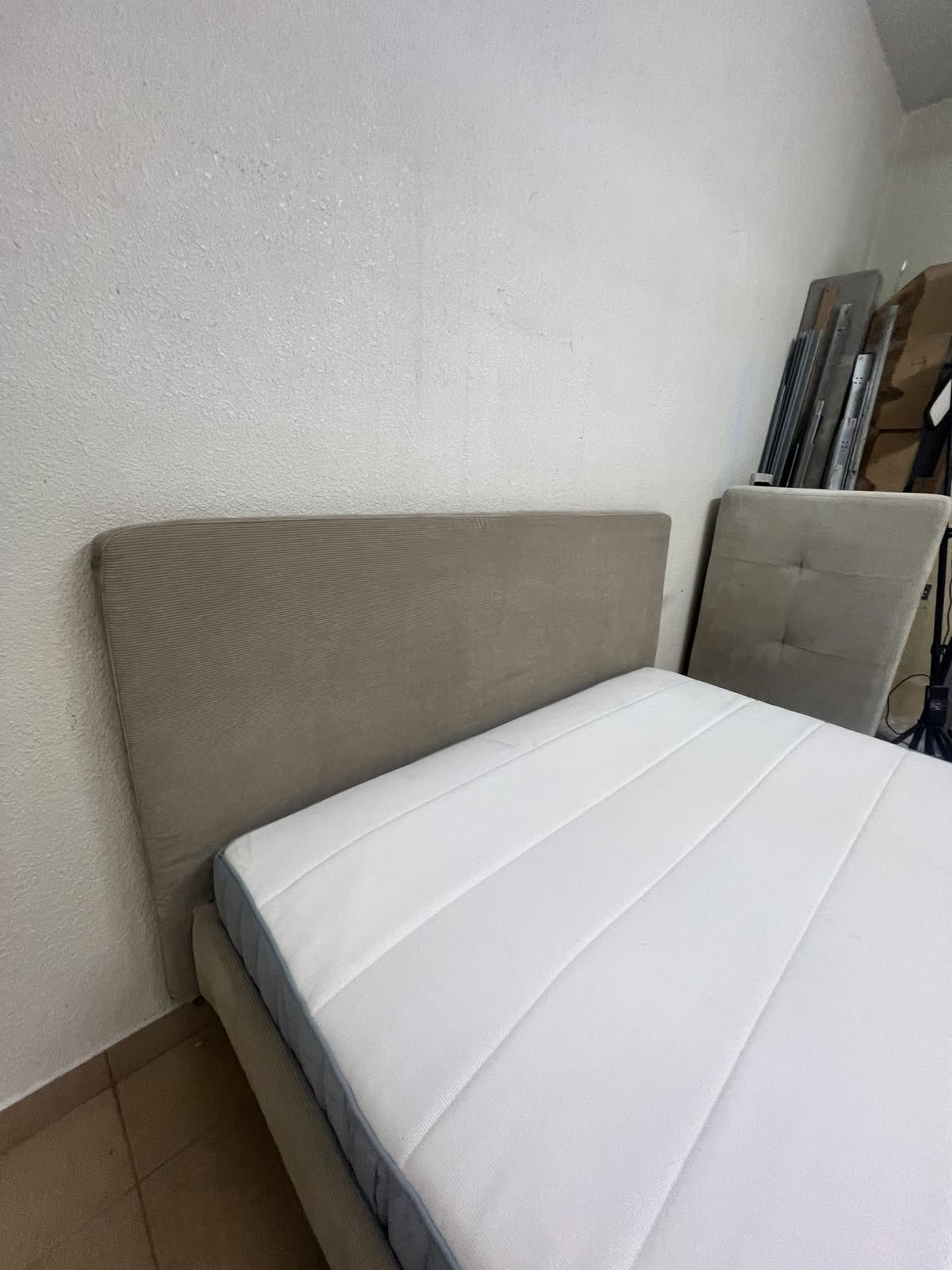 An IKEA bed with a foam and spring mattress—resembling the VALEVÅG or VESTERÖY models—featuring an upholstered bed frame in light gray or beige. - Image 8