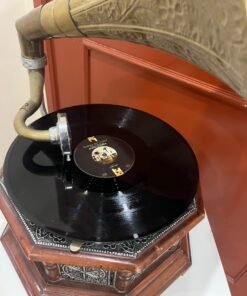 A vintage-style gramophone featuring an octagonal wooden base adorned with hand-engraved metalwork and a large, ornate brass horn, bearing the famous "His Master's Voice" logo. - Image 3