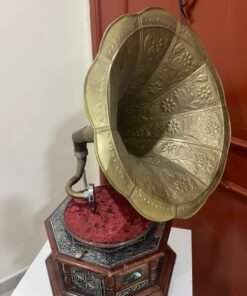 A vintage-style gramophone featuring an octagonal wooden base adorned with hand-engraved metalwork and a large, ornate brass horn, bearing the famous "His Master's Voice" logo. - Image 10