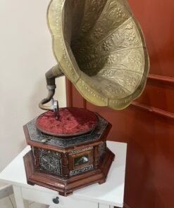 A vintage-style gramophone featuring an octagonal wooden base adorned with hand-engraved metalwork and a large, ornate brass horn, bearing the famous "His Master's Voice" logo. - Image 12