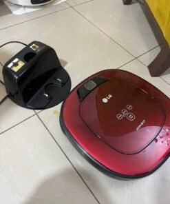 Red square-shaped robotic vacuum cleaner by LG (model LG Hom-Bot VR6270LVMB) with its charging base. - Image 5