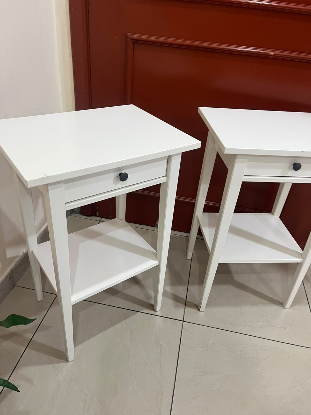 Two white IKEA HEMNES bedside tables (approximately 46x35 cm) made of solid wood.