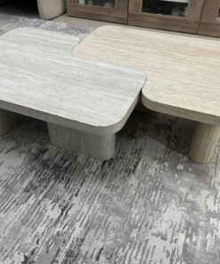 A modern two-piece coffee table set featuring an interlocking geometric design in beige, with a pattern that mimics stone or travertine. - Image 2