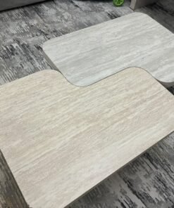 A modern two-piece coffee table set featuring an interlocking geometric design in beige, with a pattern that mimics stone or travertine. - Image 3