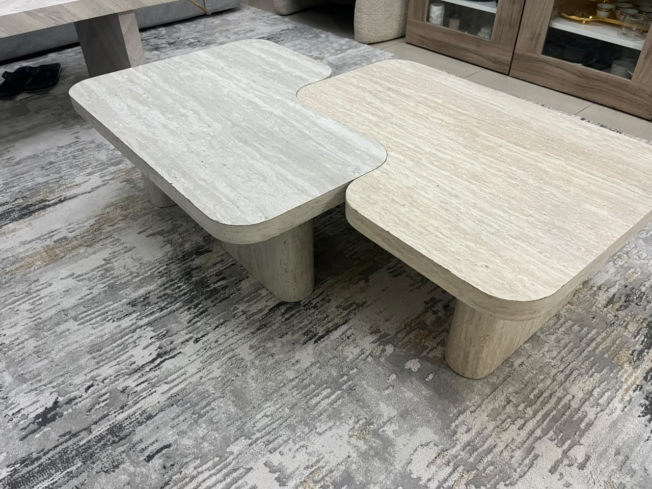 A modern two-piece coffee table set featuring an interlocking geometric design in beige, with a pattern that mimics stone or travertine. - Image 10