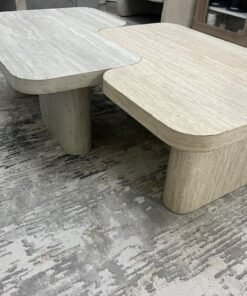 A modern two-piece coffee table set featuring an interlocking geometric design in beige, with a pattern that mimics stone or travertine. - Image 9