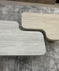 A modern two-piece coffee table set featuring an interlocking geometric design in beige, with a pattern that mimics stone or travertine. - Image 8
