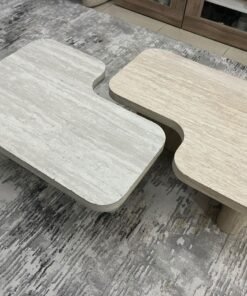 A modern two-piece coffee table set featuring an interlocking geometric design in beige, with a pattern that mimics stone or travertine.