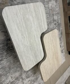 A modern two-piece coffee table set featuring an interlocking geometric design in beige, with a pattern that mimics stone or travertine. - Image 5