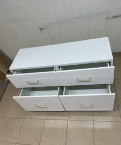 A modern, low-profile white chest of drawers (dresser) featuring a soft white finish, four spacious drawers (or double-fronted drawers), and gold or copper-toned pulls, all set on raised white legs. The design resembles contemporary storage units like the IKEA BESTÅ system or similar four-drawer cabinets. - Image 9