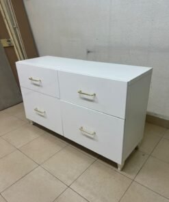 A modern, low-profile white chest of drawers (dresser) featuring a soft white finish, four spacious drawers (or double-fronted drawers), and gold or copper-toned pulls, all set on raised white legs. The design resembles contemporary storage units like the IKEA BESTÅ system or similar four-drawer cabinets. - Image 4