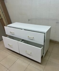 A modern, low-profile white chest of drawers (dresser) featuring a soft white finish, four spacious drawers (or double-fronted drawers), and gold or copper-toned pulls, all set on raised white legs. The design resembles contemporary storage units like the IKEA BESTÅ system or similar four-drawer cabinets. - Image 8
