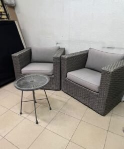 A compact outdoor seating set consisting of two grey synthetic rattan (PE Rattan) armchairs with comfortable grey cushions, plus a round table with a glass top. - Image 6