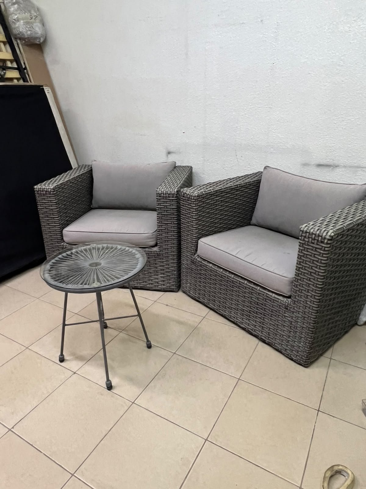 A compact outdoor seating set consisting of two grey synthetic rattan (PE Rattan) armchairs with comfortable grey cushions, plus a round table with a glass top. - Image 6