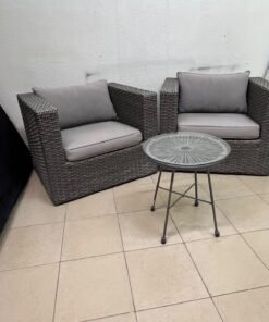 A compact outdoor seating set consisting of two grey synthetic rattan (PE Rattan) armchairs with comfortable grey cushions, plus a round table with a glass top. - Image 4