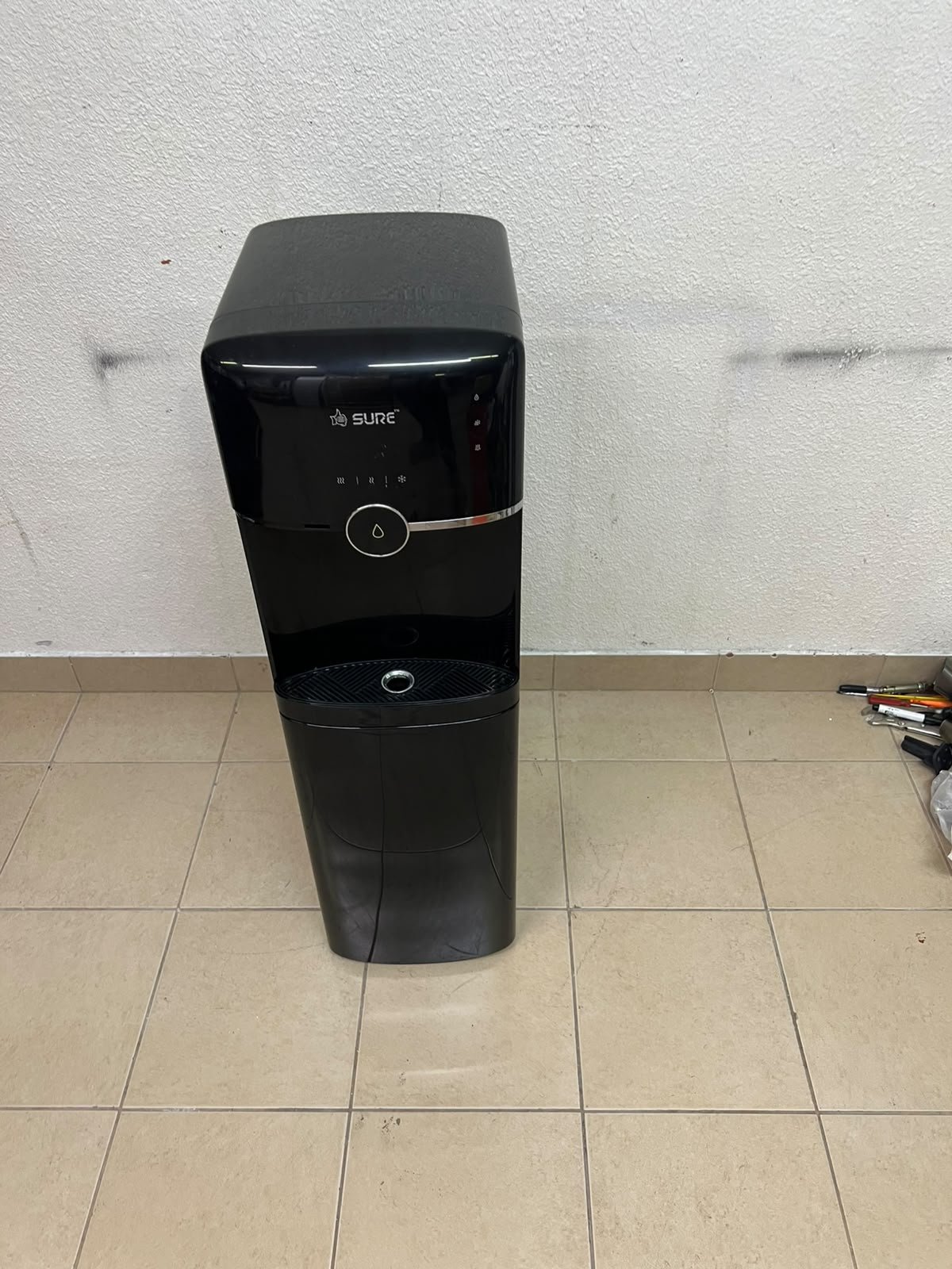 A black, freestanding water cooler from Sure—specifically a bottom-loading model (such as the SBL70 or SBL1970BP)—that allows the water bottle to be easily placed inside the bottom compartment. - Image 3