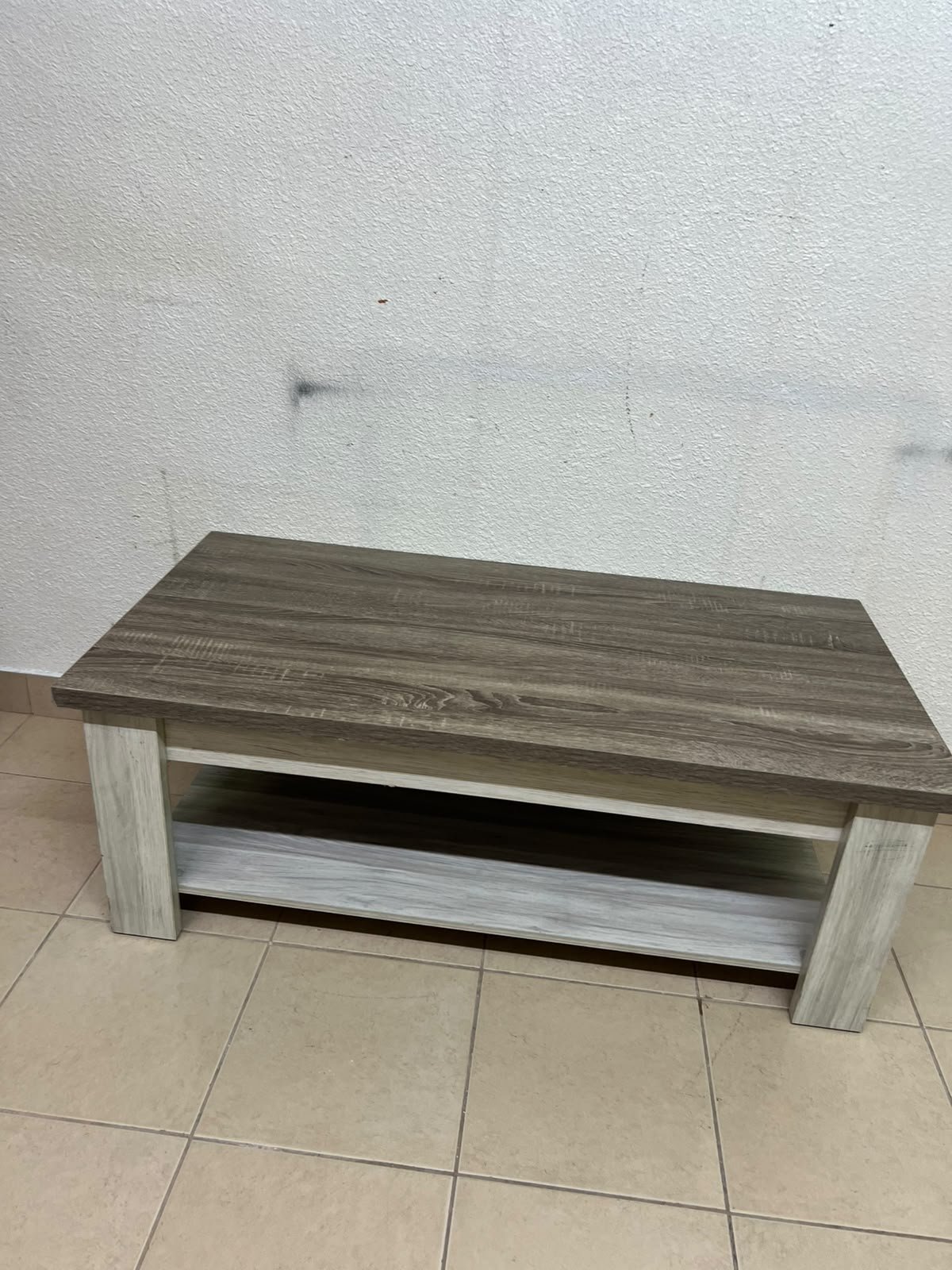 A rectangular coffee table made of engineered wood featuring a two-tone design; the tabletop comes in a greyish-brown wood finish, while the frame, legs, and lower shelf are white or light grey. It resembles the "Angelic" coffee table from Home Box. - Image 4