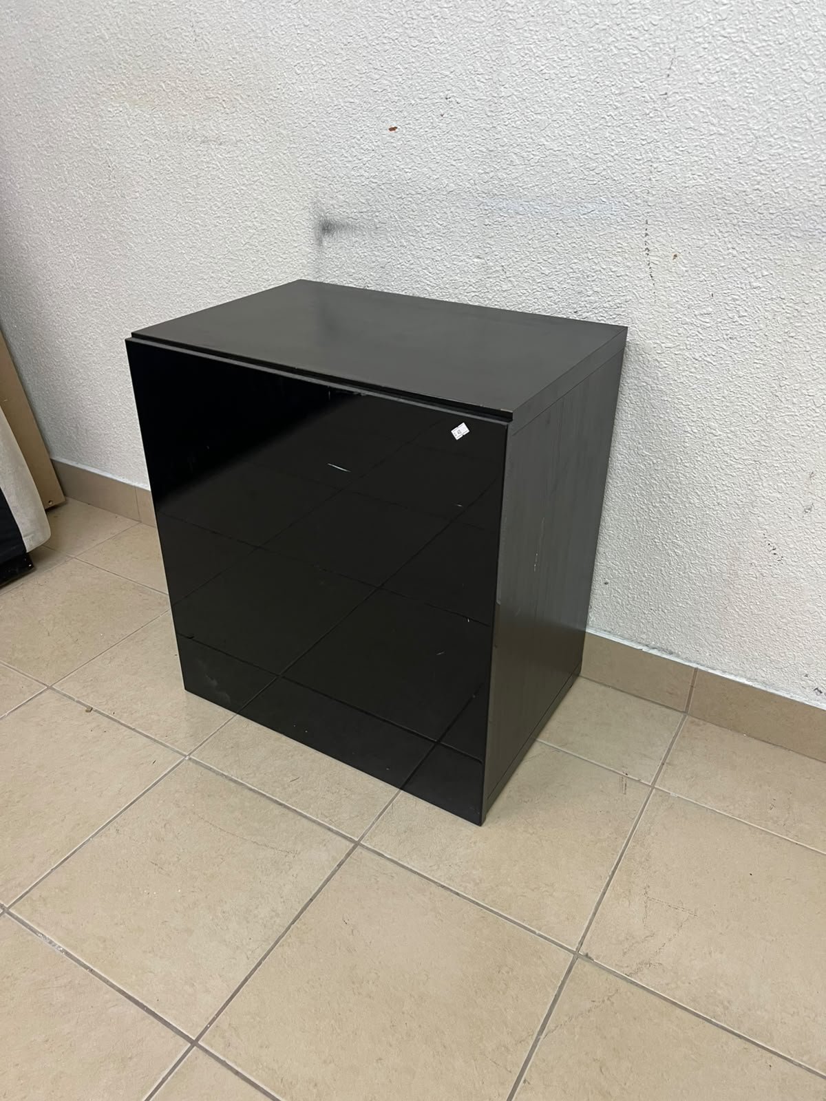 An IKEA BESTÅ series storage cabinet, featuring a high-gloss black door (Selsviken front).