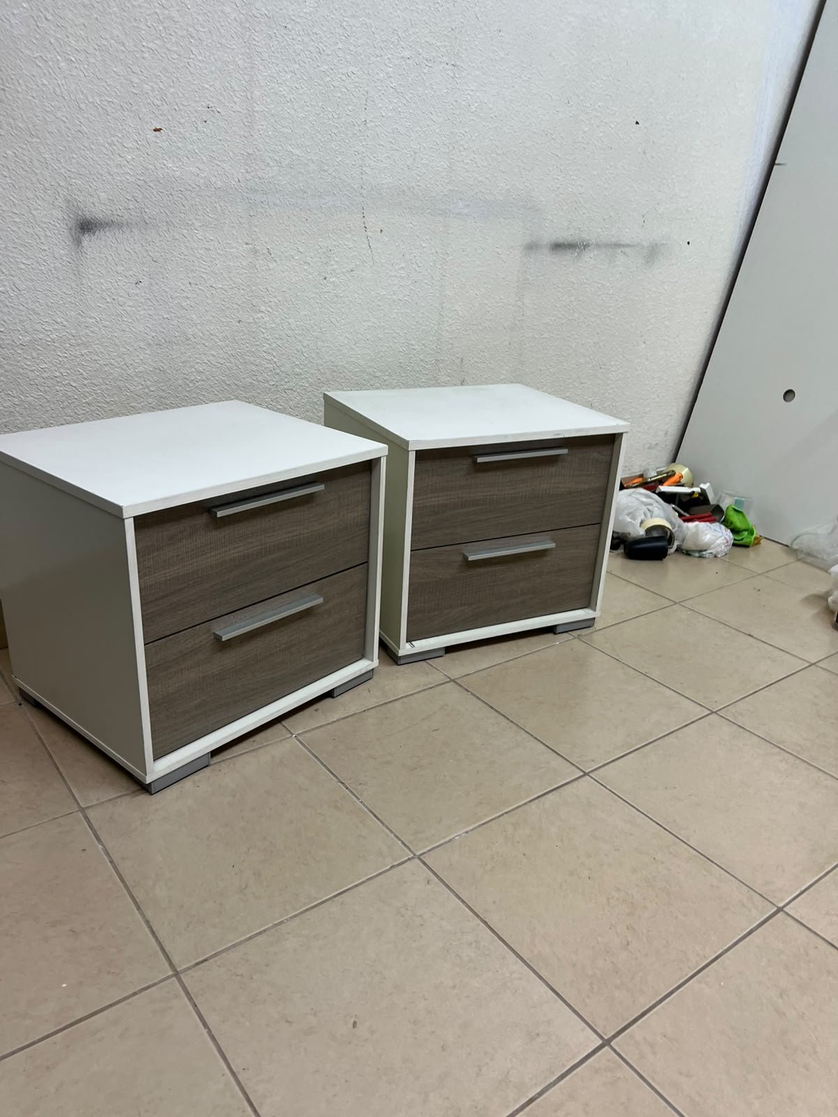 Two modern, two-tone (white and walnut/gray) bedside tables featuring two drawers and silver handles, similar to the "Marissa" or "Thomas" 2-drawer nightstands (white/walnut) available on the local market.