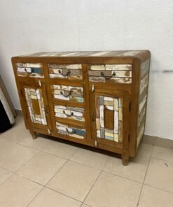 This is a sideboard or buffet cabinet made of natural wood, featuring a vintage-rustic design and distinguished by drawers and doors with distressed, multi-colored wooden panels.