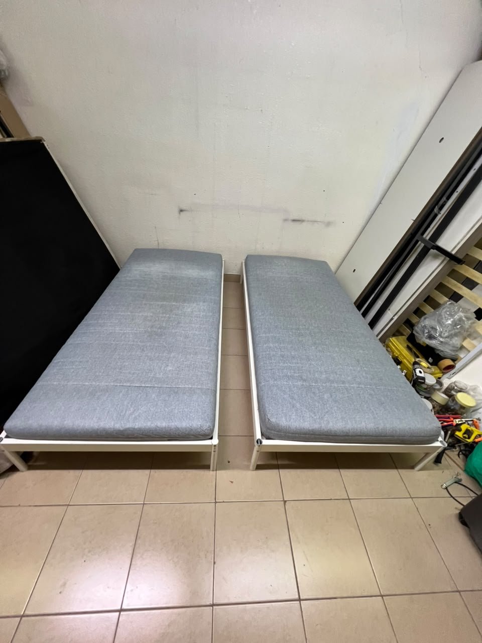 Two single beds with white metal frames, featuring lightweight foam mattresses in a light gray/blue color—similar to the ÅGOTNES foam mattress from IKEA. - Image 5
