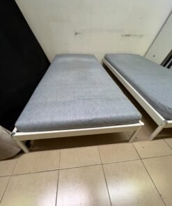 Two single beds with white metal frames, featuring lightweight foam mattresses in a light gray/blue color—similar to the ÅGOTNES foam mattress from IKEA. - Image 8