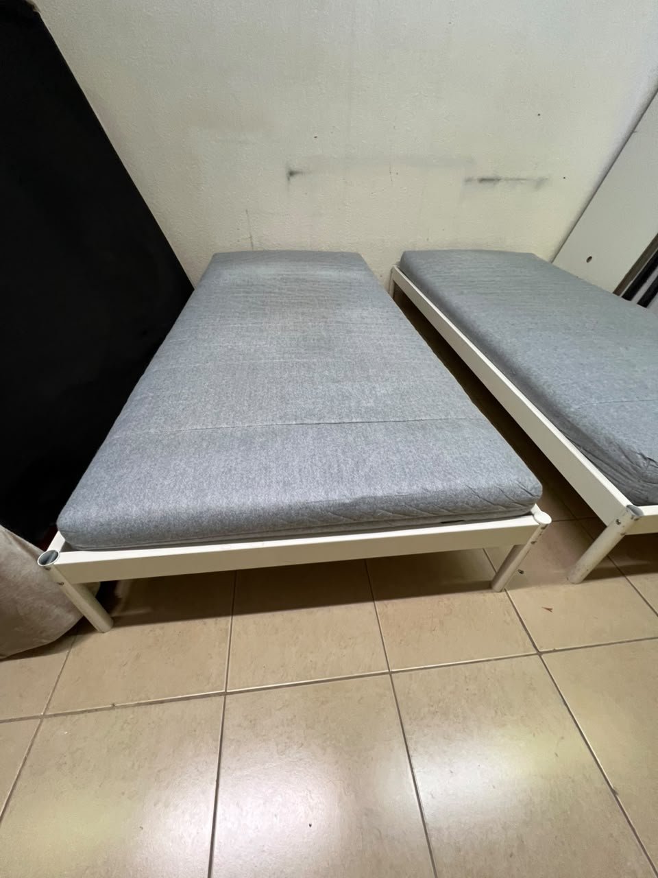 Two single beds with white metal frames, featuring lightweight foam mattresses in a light gray/blue color—similar to the ÅGOTNES foam mattress from IKEA. - Image 8