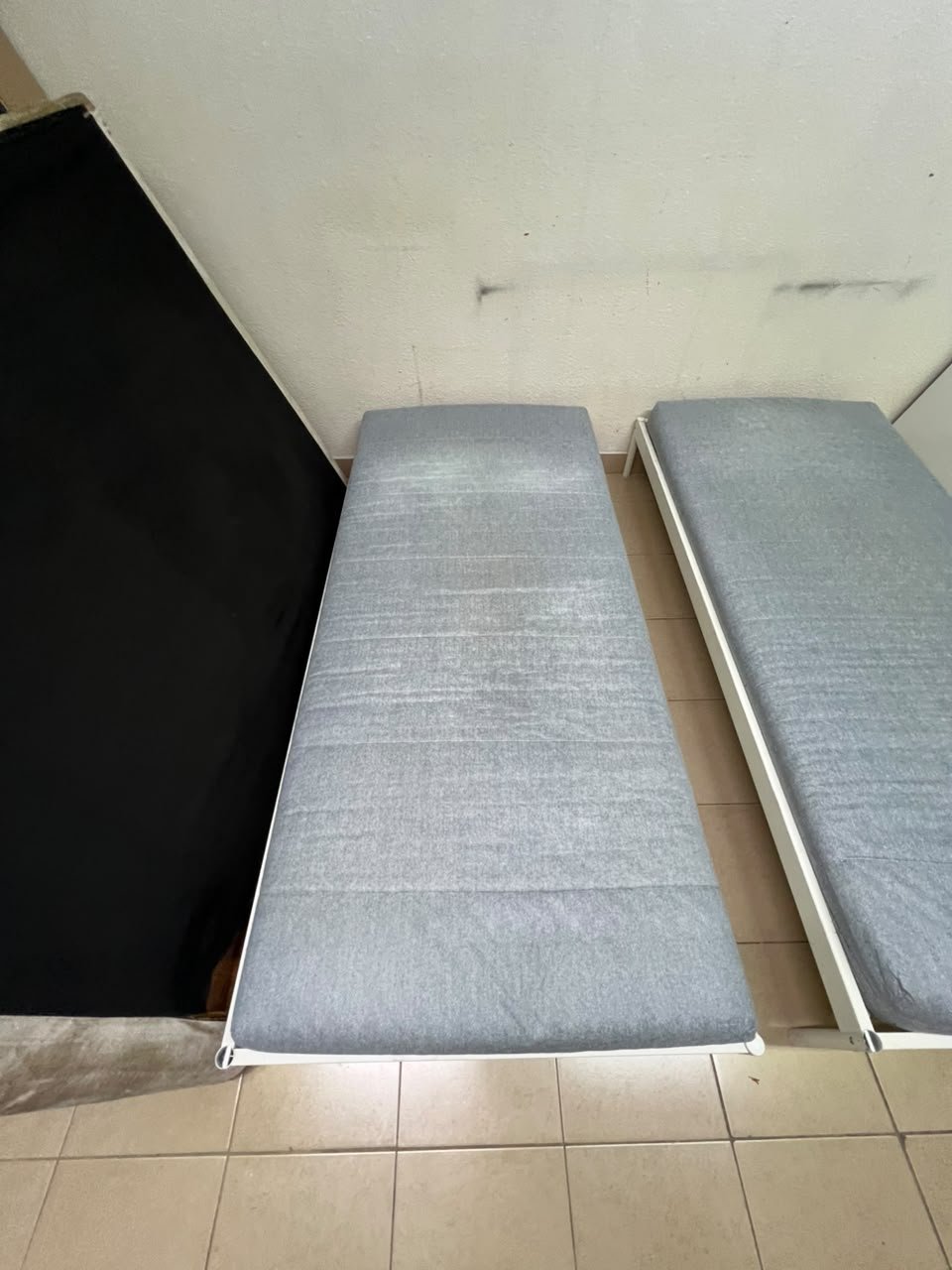 Two single beds with white metal frames, featuring lightweight foam mattresses in a light gray/blue color—similar to the ÅGOTNES foam mattress from IKEA. - Image 9
