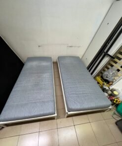 Two single beds with white metal frames, featuring lightweight foam mattresses in a light gray/blue color—similar to the ÅGOTNES foam mattress from IKEA. - Image 3