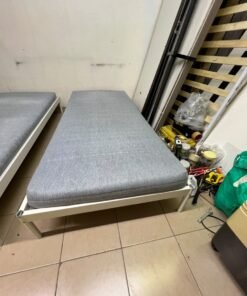 Two single beds with white metal frames, featuring lightweight foam mattresses in a light gray/blue color—similar to the ÅGOTNES foam mattress from IKEA. - Image 4