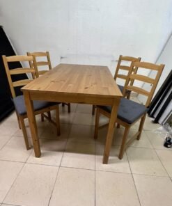 Solid wood dining table with 4 chairs (IKEA JOKKMOKK model) in an antique-stain pine finish, including grey seat cushions (IKEA JUSTINA model).