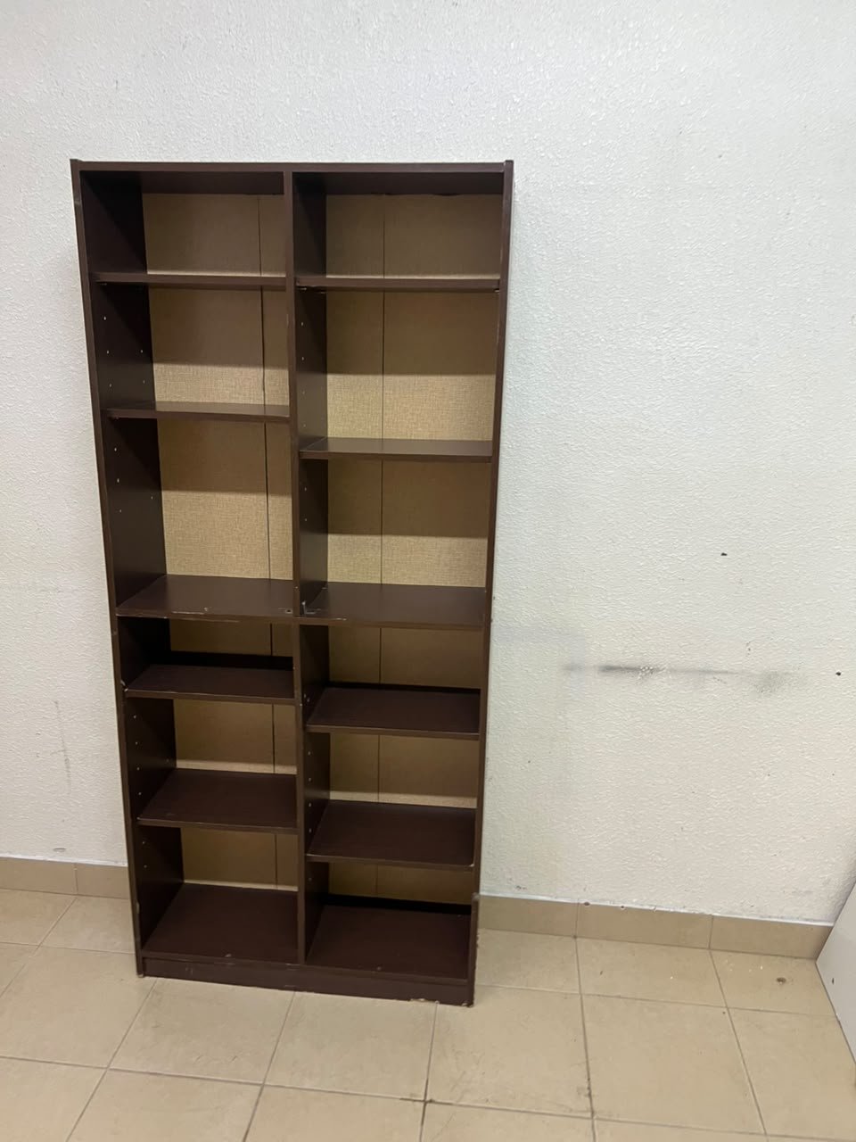 A dark brown open wooden bookcase (Walid)—a tall storage unit divided into two main sections, featuring multiple adjustable shelves.
