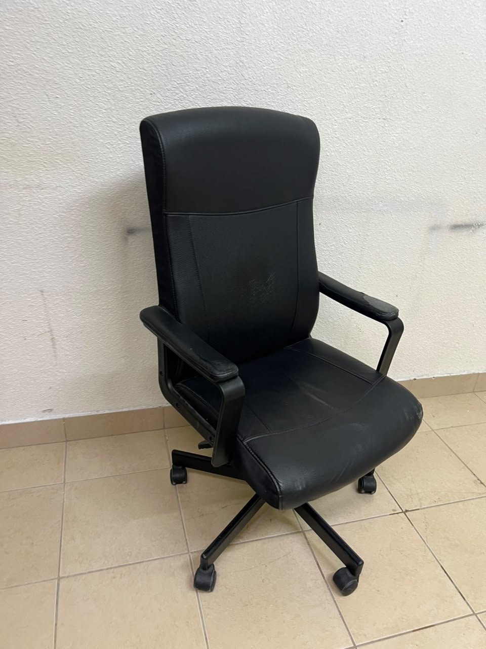 An IKEA swivel office chair—specifically the MILLBERGET model—in black.