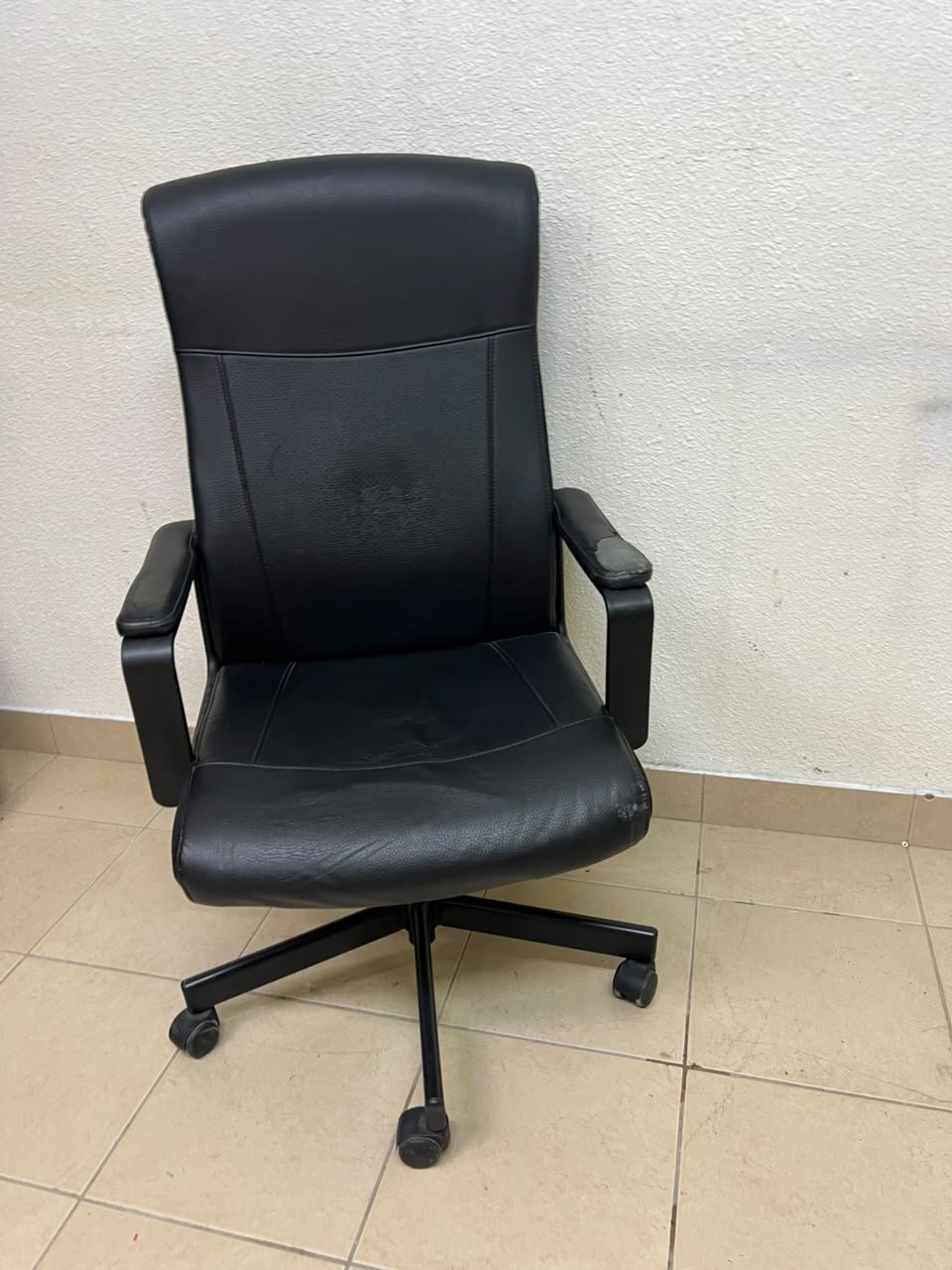 An IKEA swivel office chair—specifically the MILLBERGET model—in black. - Image 4