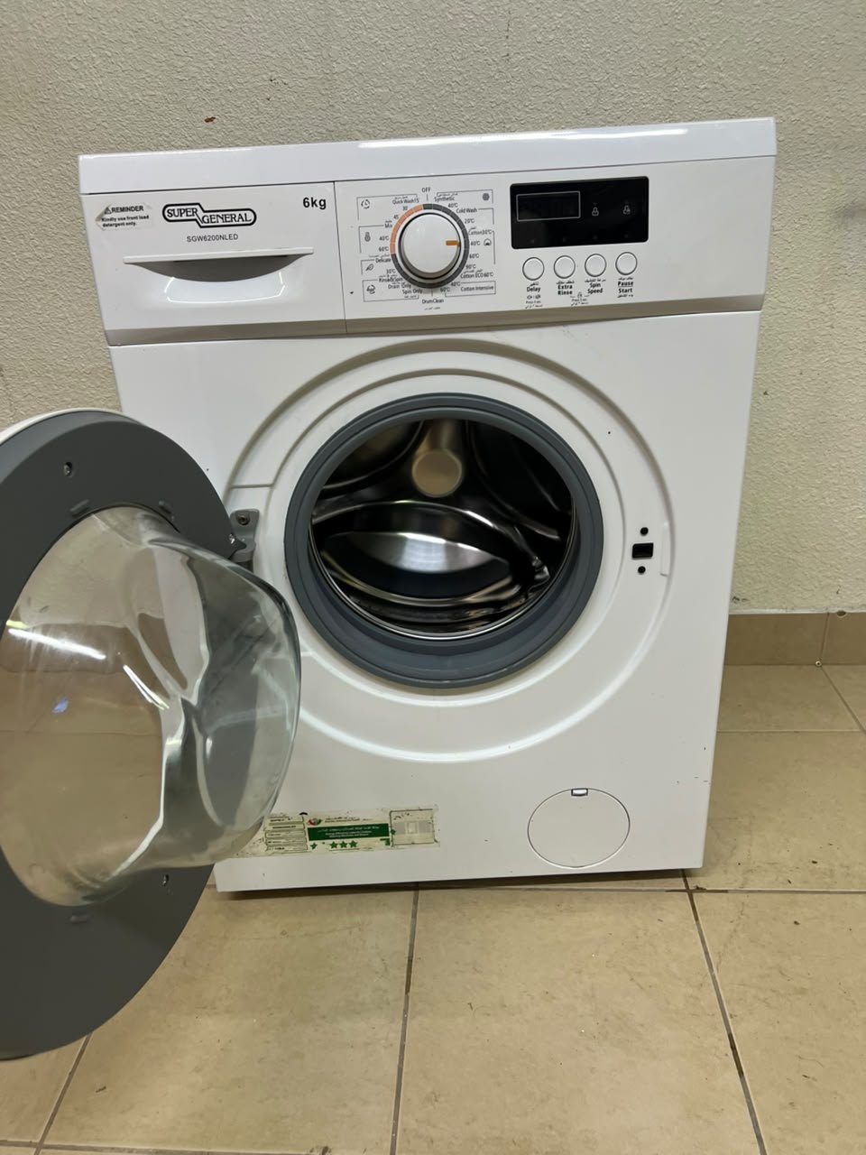 The image shows a Super General front-load washing machine (6 kg capacity, 1000 RPM, model similar to SGW6100NLED). - Image 6