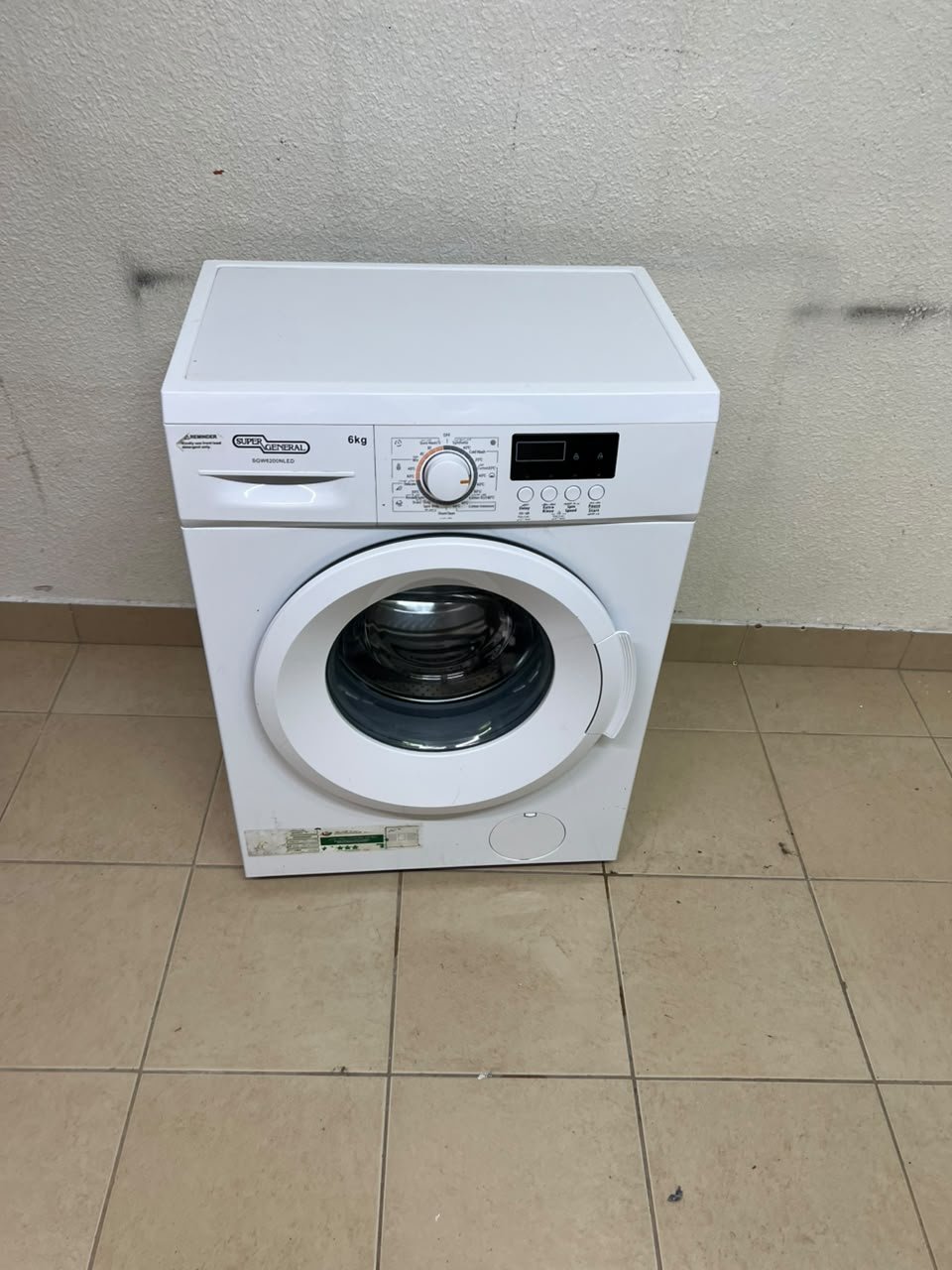 The image shows a Super General front-load washing machine (6 kg capacity, 1000 RPM, model similar to SGW6100NLED). - Image 7