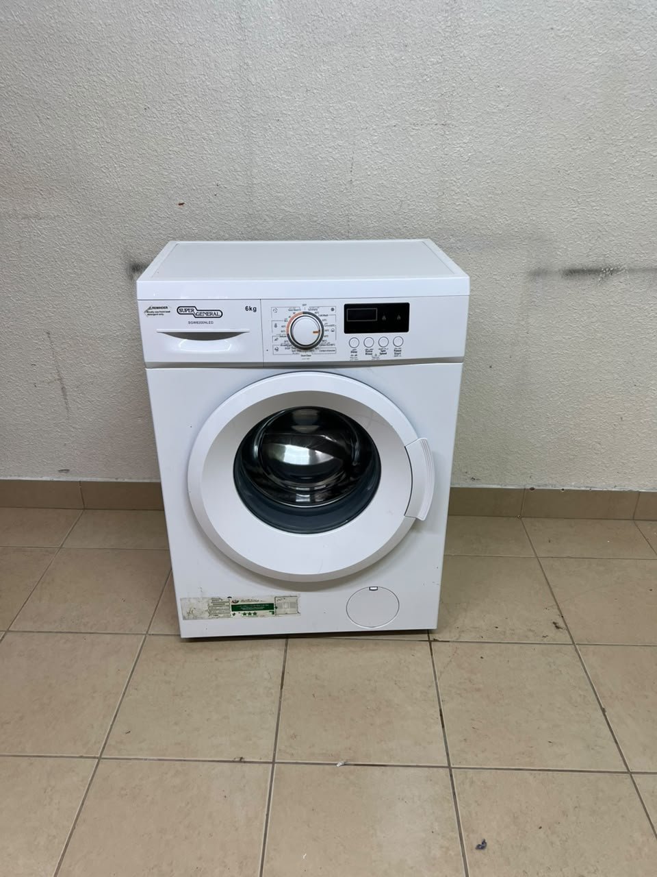 The image shows a Super General front-load washing machine (6 kg capacity, 1000 RPM, model similar to SGW6100NLED). - Image 8