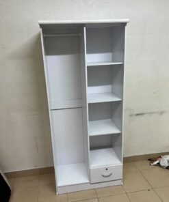 A freestanding, white, geometric wooden wardrobe (closet).