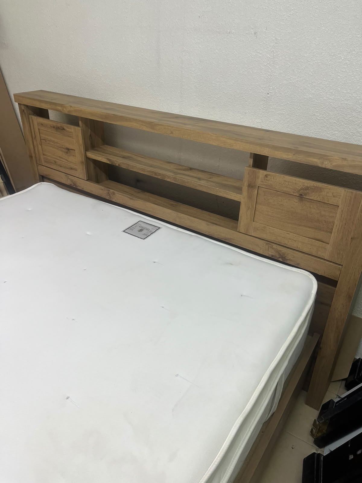 A modern-style wooden double bed (king or queen size) with a mattress, featuring a headboard equipped with shelves and storage cabinets—from Home Centre. - Image 9