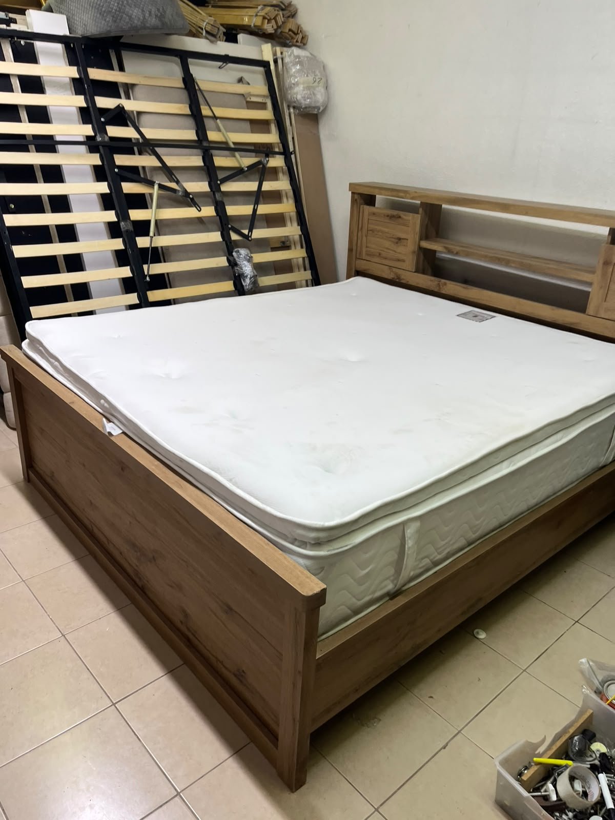 A modern-style wooden double bed (king or queen size) with a mattress, featuring a headboard equipped with shelves and storage cabinets—from Home Centre. - Image 10