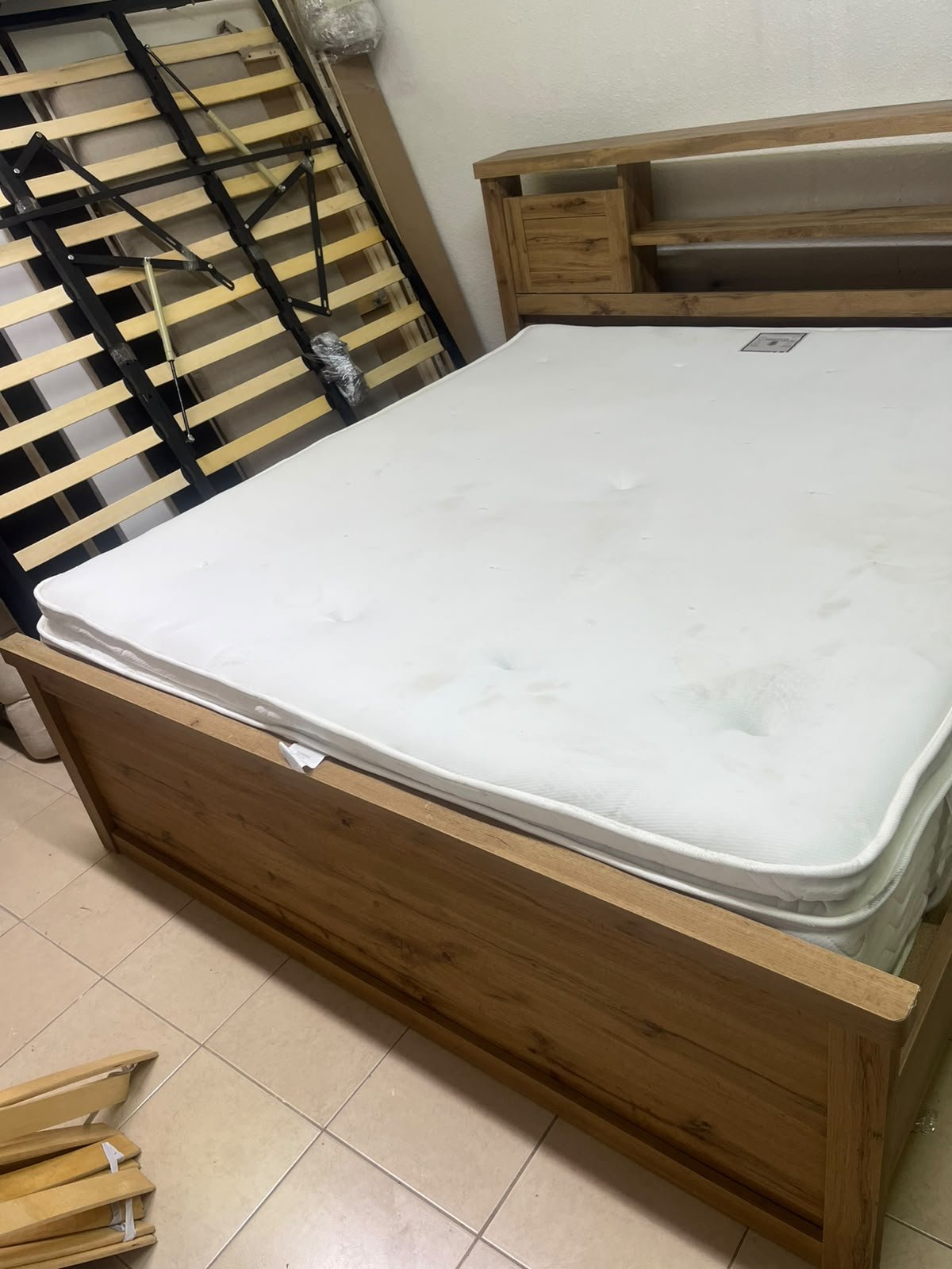 A modern-style wooden double bed (king or queen size) with a mattress, featuring a headboard equipped with shelves and storage cabinets—from Home Centre. - Image 11