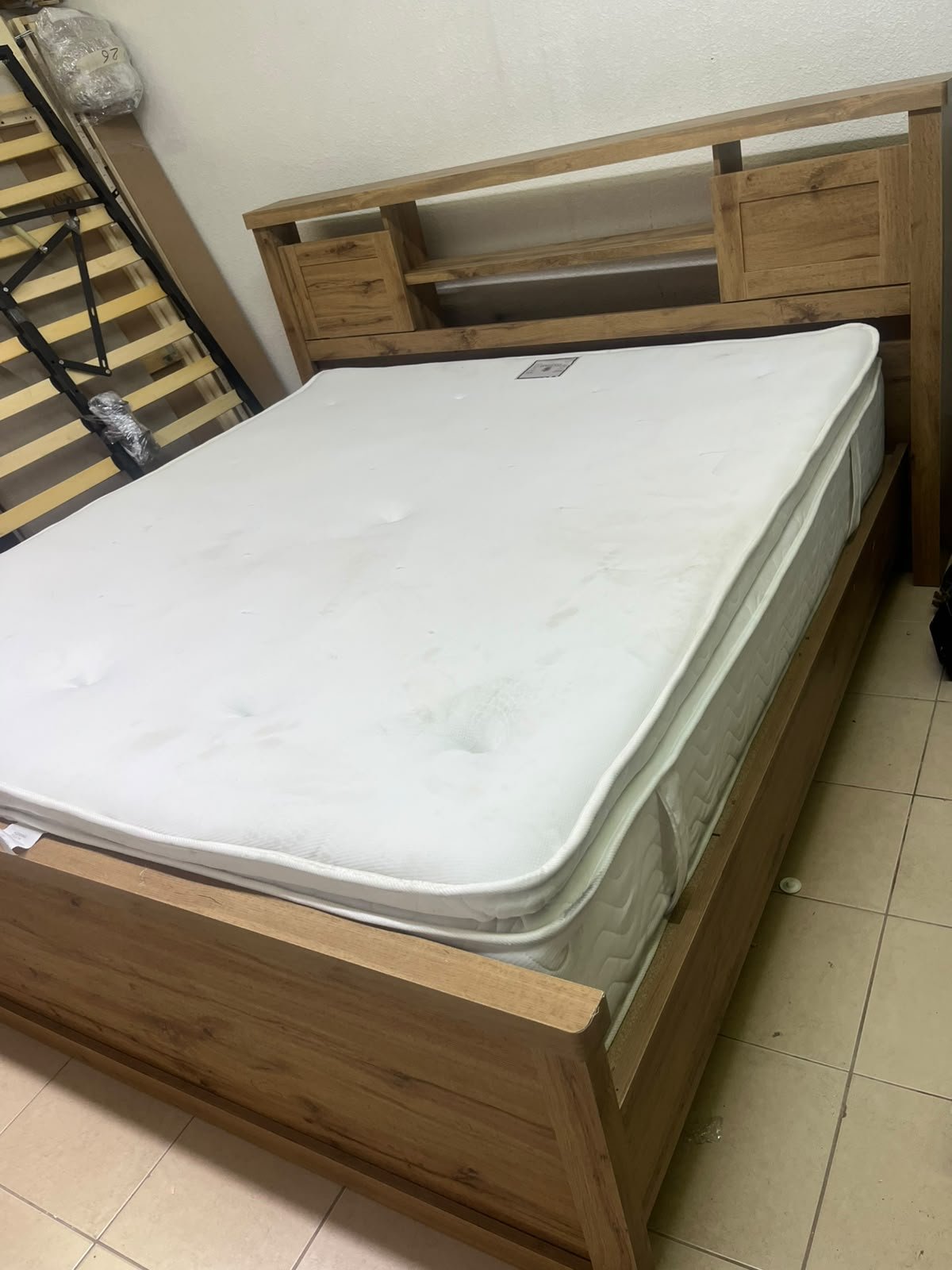 A modern-style wooden double bed (king or queen size) with a mattress, featuring a headboard equipped with shelves and storage cabinets—from Home Centre. - Image 3